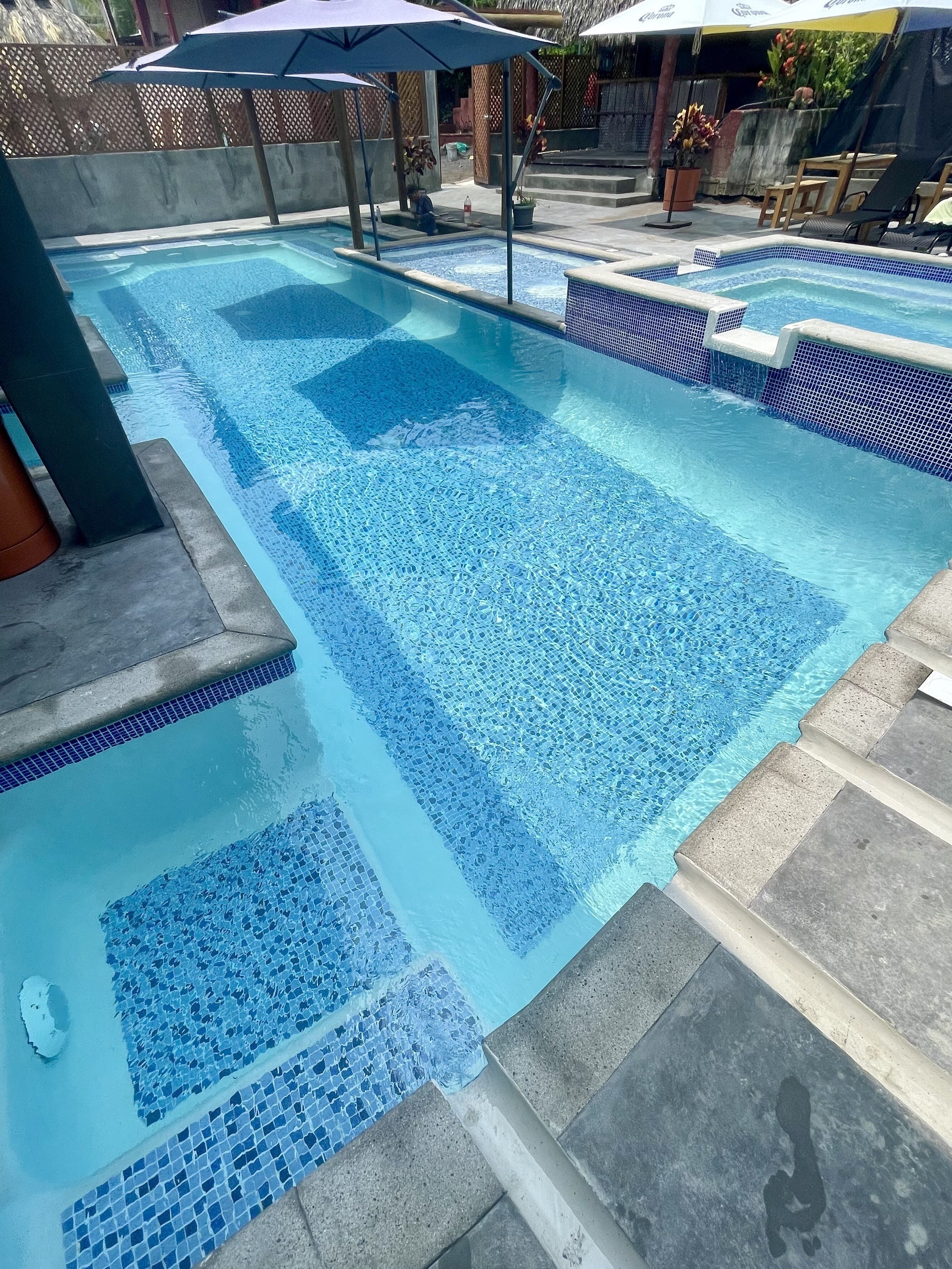 A swimming pool with tiled edges and a clear blue water surface.