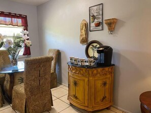 Enjoy meals with friends and family at this dining area, featuring a round table and comfortable chairs.