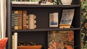 A bookshelf with books, a bowl, and a book titled 'Tomato Chases Waterfalls'. - Picturesque Garden Retreat w/Deck With Hot Tub (Dunsmuir)