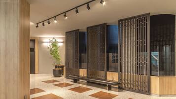 Contemporary interior with a geometric floor, decorative partition, and sleek seating area.