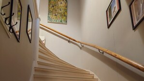 A staircase with wooden steps and a wooden handrail, leading to an upper floor. - Historic Villa in the heart of Gränna (Jönköpings län)