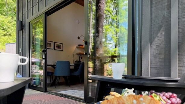 An outdoor dining area with a table set for breakfast, including croissants, strawberries, and grapes. - Early Fall Getaway - 2 (Sevierville)