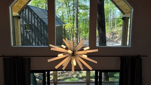 A room with a large window, a wooden ceiling, and a modern light fixture. - Early Fall Getaway - 2 (Sevierville)