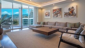 A modern living room with a sectional sofa, a coffee table, and artwork on the walls. - The Stylish Apt. of Madeira Palace CC (Funchal)