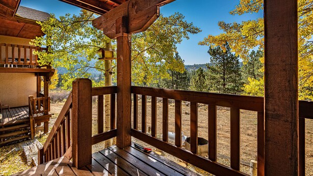 A wooden deck with a view of autumn trees and a mountainous landscape. - Spacious Townhouse, Firepit, Walkable to Park/Golf/Tennis, Foosball, Two Decks (Angel Fire)