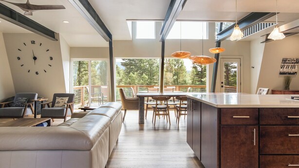 A modern kitchen with a dining area, large windows, and a view of the outdoors. - Modern Lodge w/Hot Tub, Beautiful View, Foosball, 2 Car Garage, Gourmet Kitchen (Angel Fire)