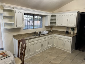 Fridge, microwave, stovetop, coffee/tea maker