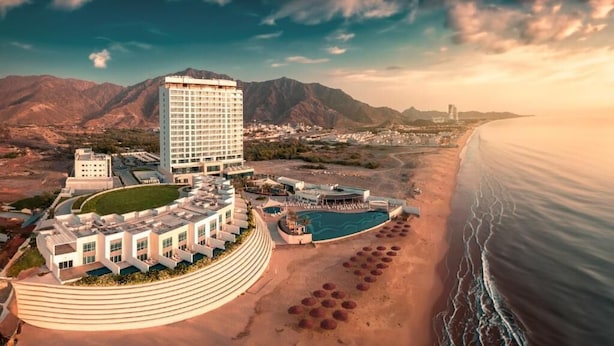 A resort with a large building, a pool, and a beach. - Royal M Al Aqah Beach Hotel And Resort by Gewan (Al Aqah)
