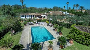 A swimming pool surrounded by potted plants and outdoor furniture, with a house in the background. - Adorable Family Villa, A/C, Beautiful Landscaped Garden, Private Pool close to Pollença & Beaches! (Pollença)