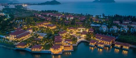 An aerial view of a resort with multiple buildings, a marina, and a coastline.