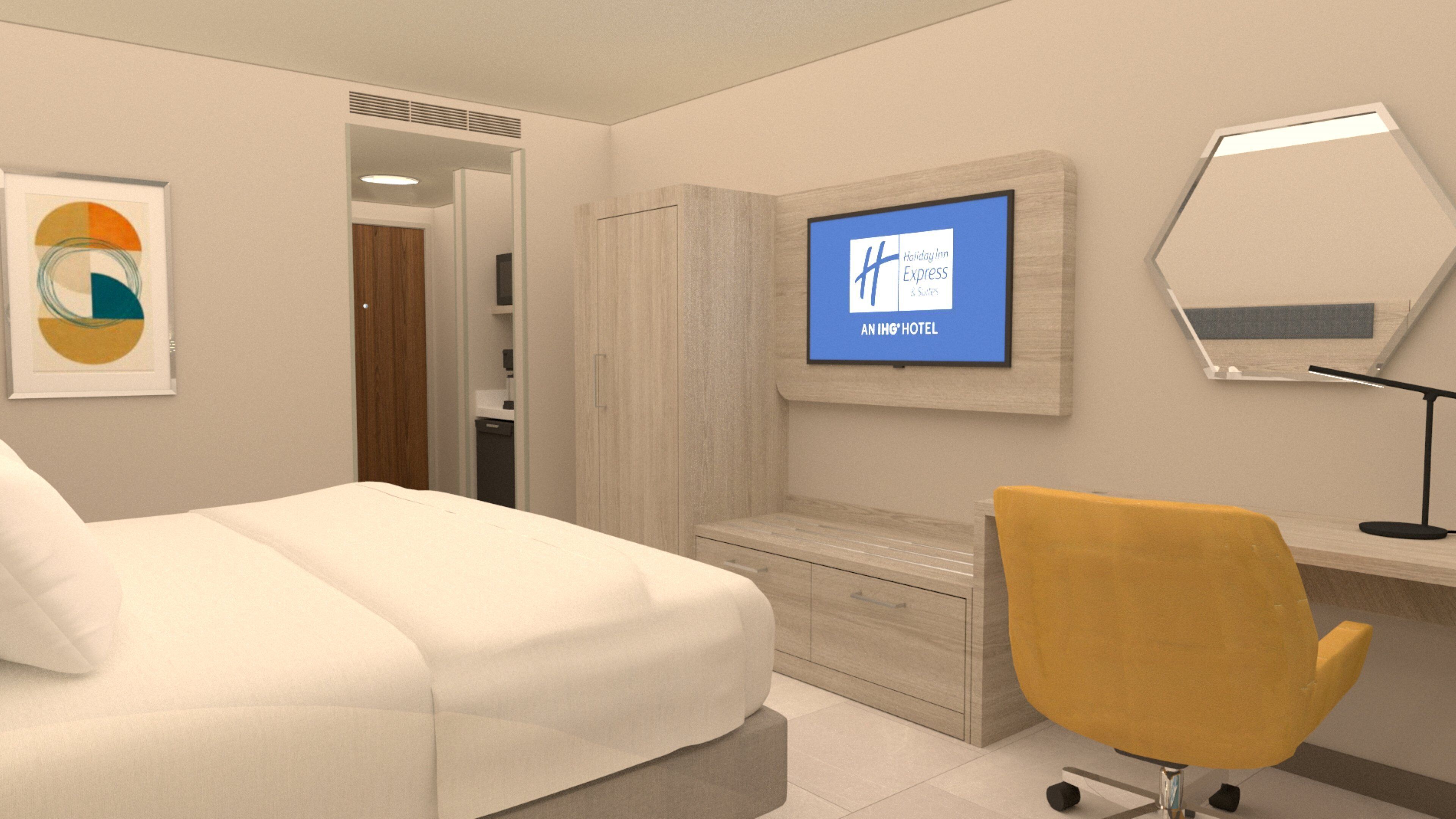 A hotel room with a bed, a desk, a chair, a television, and a mirror.