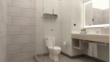 Un baño moderno con inodoro, lavamanos y espejo.