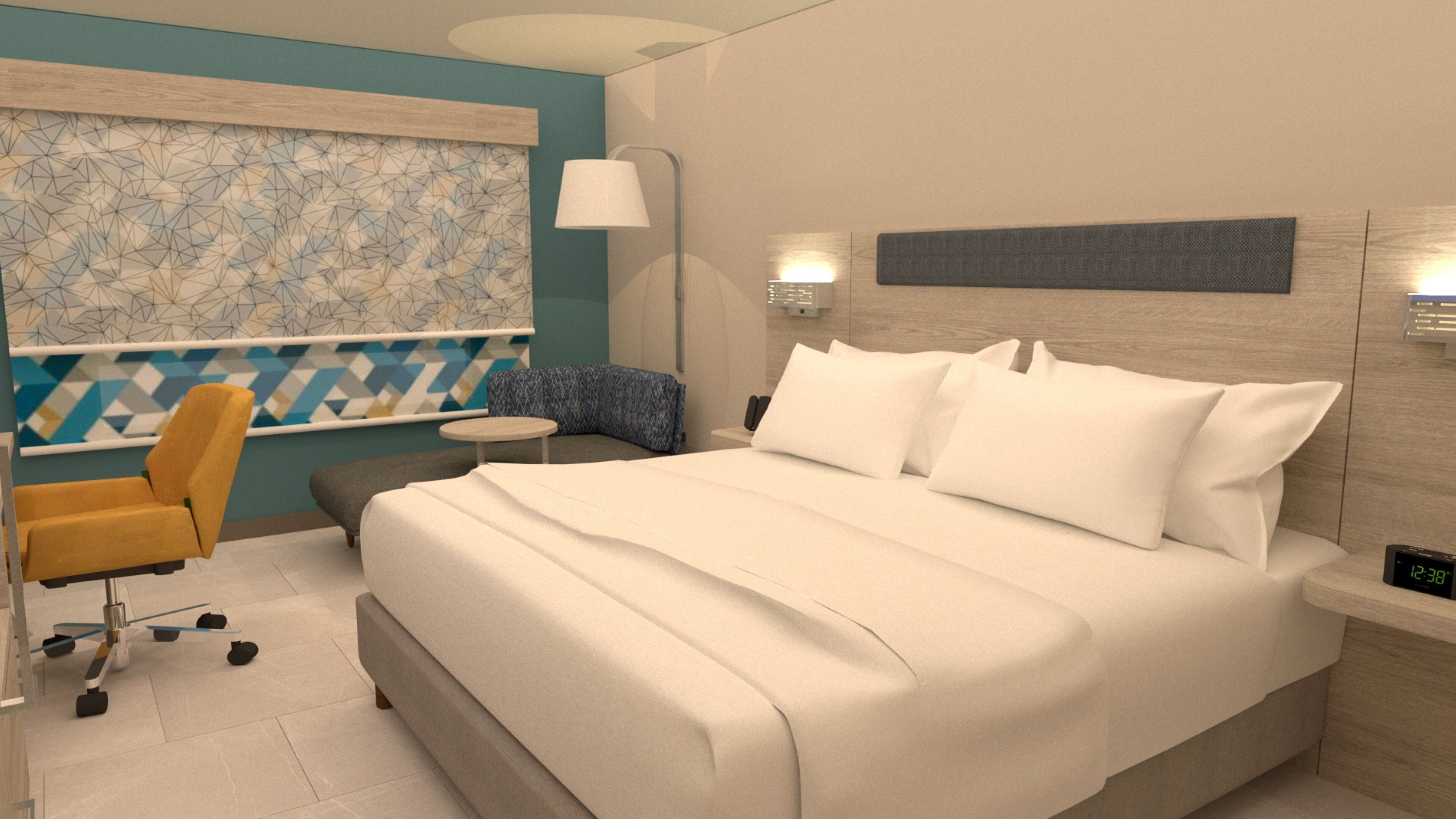 A modern hotel room with a large bed, a small round table, a chair, and a wall-mounted lamp.