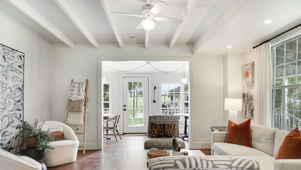 A spacious living room with a white ceiling fan, a large window with curtains, and a view of the outdoors. - Luxury Round Top Farmhouse  / 6mil to The Square (Round Top)