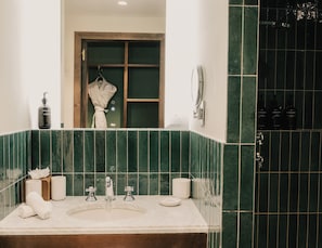 A bathroom with a large mirror, two sinks, a robe, and toiletries. - Le Val Thorens (Les Belleville)