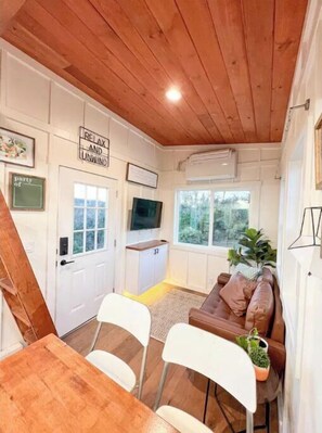 Cozy living space with a dining area, sofa, and kitchenette.