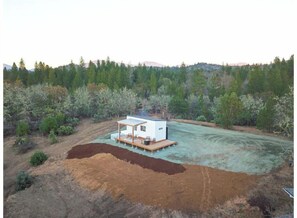 Situated in a serene forest, this cabin offers a peaceful retreat with a deck for relaxation and dining.