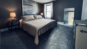 A bedroom with a bed, two bedside tables, a ceiling fan, a window with curtains, and a mirror. - Spacious ‘GEM’ of the city (Geneva)