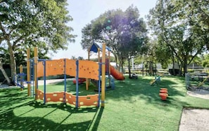 A playground with climbing structures, slides, and a covered play area.