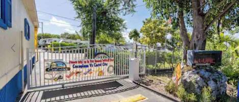 A gated entrance with a sign indicating a car rental service.
