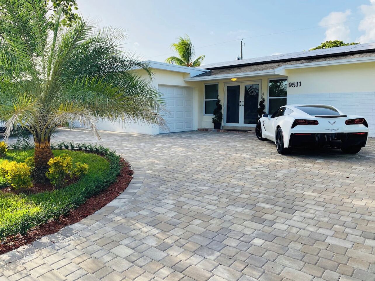 A white sports car parked in front of a building with the number 9511.