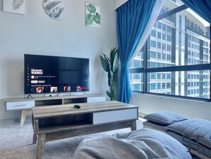 Comfort Suite | Living area | 35-inch LED TV with digital channels, TV, streaming services - Homesuite' Home at Jesselton Quay (Kota Kinabalu)