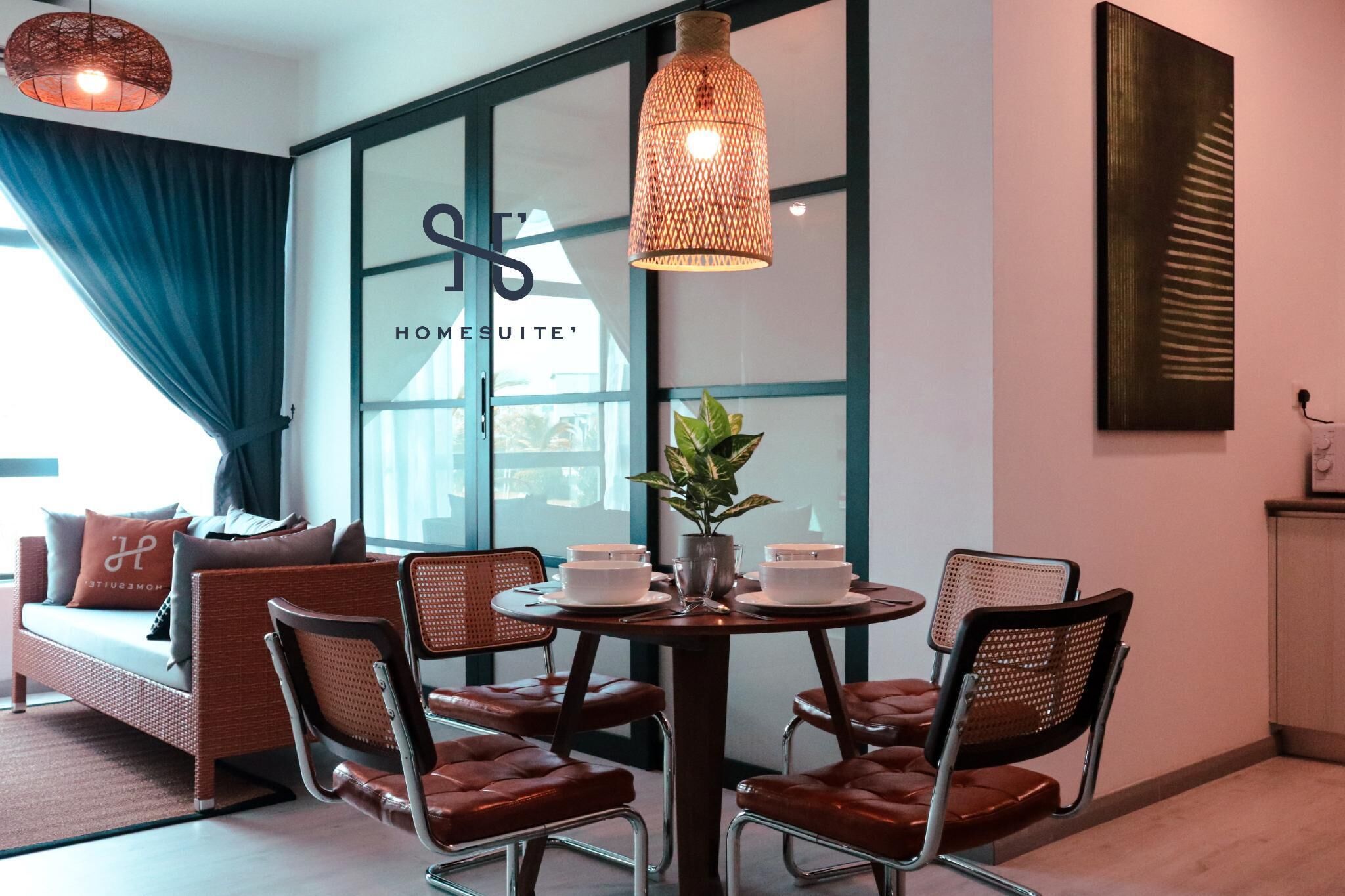 A modern living room with a sofa, dining table, chairs, and a large window.