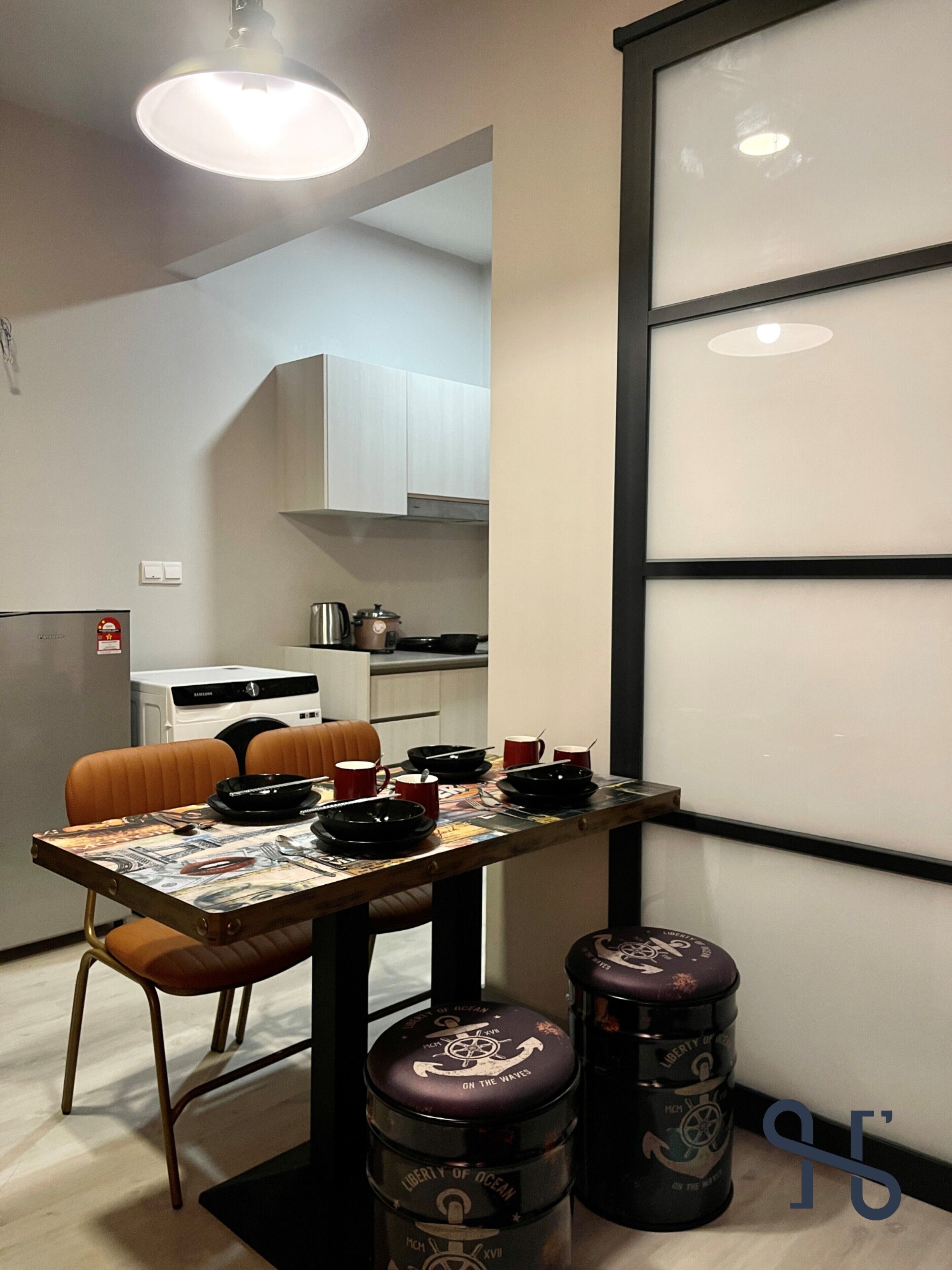 A modern dining area with a table set for four, a kitchen in the background, and a large window with blinds.