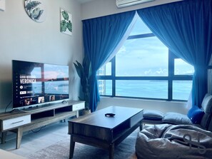 Comfort Suite | Living area | 35-inch LED TV with digital channels, TV, streaming services - Homesuite' Home at Jesselton Quay (Kota Kinabalu)