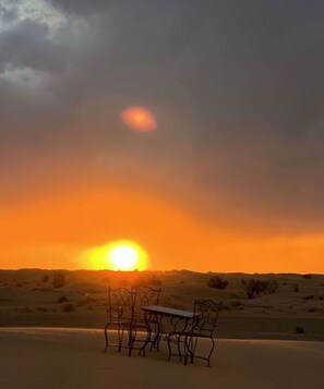 Experience the serene desert landscape from the comfort of your dining area at Saharian Luxury Camp.