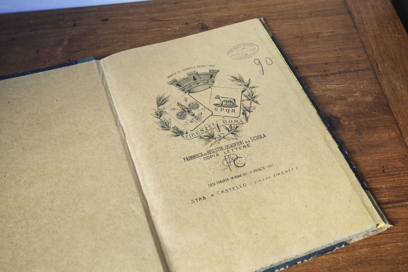 An open book with text and a logo on the right page.