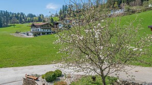 A large house with a garden and a view of the surrounding landscape.