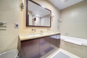 A bathroom with a double sink, a large mirror, a shower, and a bathtub. - Waterfront Sea View Apt w/ Wow Factor on The Palm (Dubai)