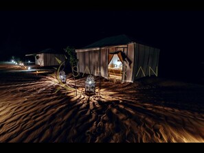 Experience the warmth of a desert retreat in this inviting guest area with a spacious interior and cozy ambiance.