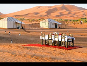 Guests can dine in style amidst the desert landscape.