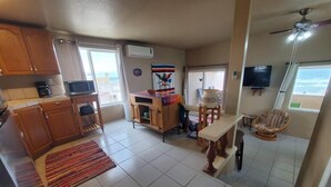 A compact living space with a kitchen area, a dining table, a sofa, and a TV. - Hacienda De Sol y Luna- 2 bdrm Apartment (Playa Encanto)