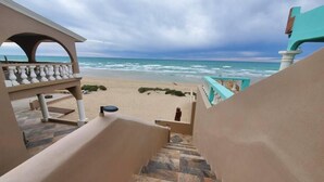 A staircase leading to a beach with a view of the ocean. - Hacienda De Sol y Luna- 2 bdrm Apartment (Playa Encanto)