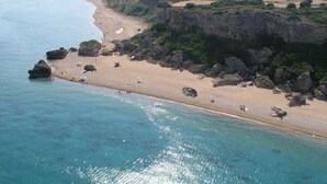 A coastal beach with clear waters, rocky outcrops, and a sandy shore. - Villa Alkionis in Kefalonia (Skala Kefalonia)