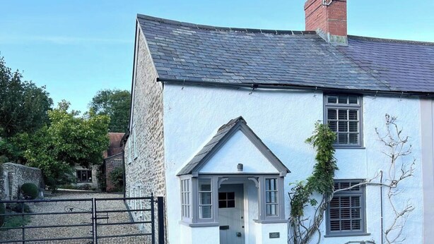 A white cottage with a gabled roof, a small porch, and a gate in front. - 2 Bedroom Cottage - Sleeps 4 - Wifi, Fireplace (Sturminster Newton)