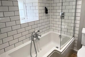 Separate tub and shower, deep soaking tub, hair dryer, towels