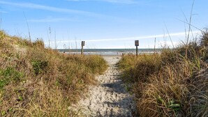A sandy beach path leading to the ocean with tall grass on either side. - Pet-Friendly Oceanfront 2-BR on Top/3rd Floor – Stunning Cherry Grove Beach Views - Blue Mist 302 (North Myrtle Beach)