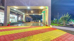 A covered walkway with a patterned floor leading to a building entrance. - The Aanandam Hotel Resort (Itarsi)