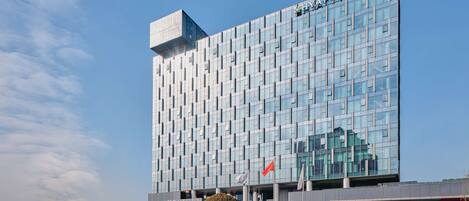 A modern Hyatt Place hotel with a reflective glass facade and a distinctive geometric pattern.