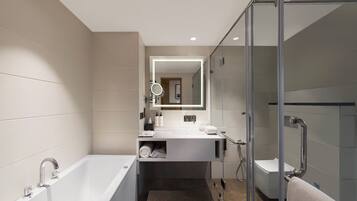 A modern bathroom with a bathtub, a glass shower enclosure, and a vanity with a mirror.