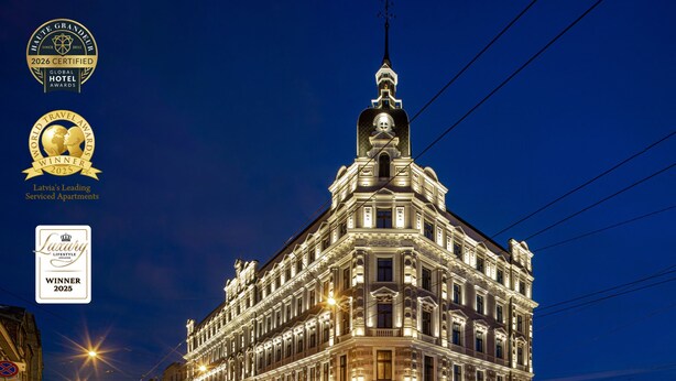 A historic building with ornate architecture, large windows, and a prominent tower.