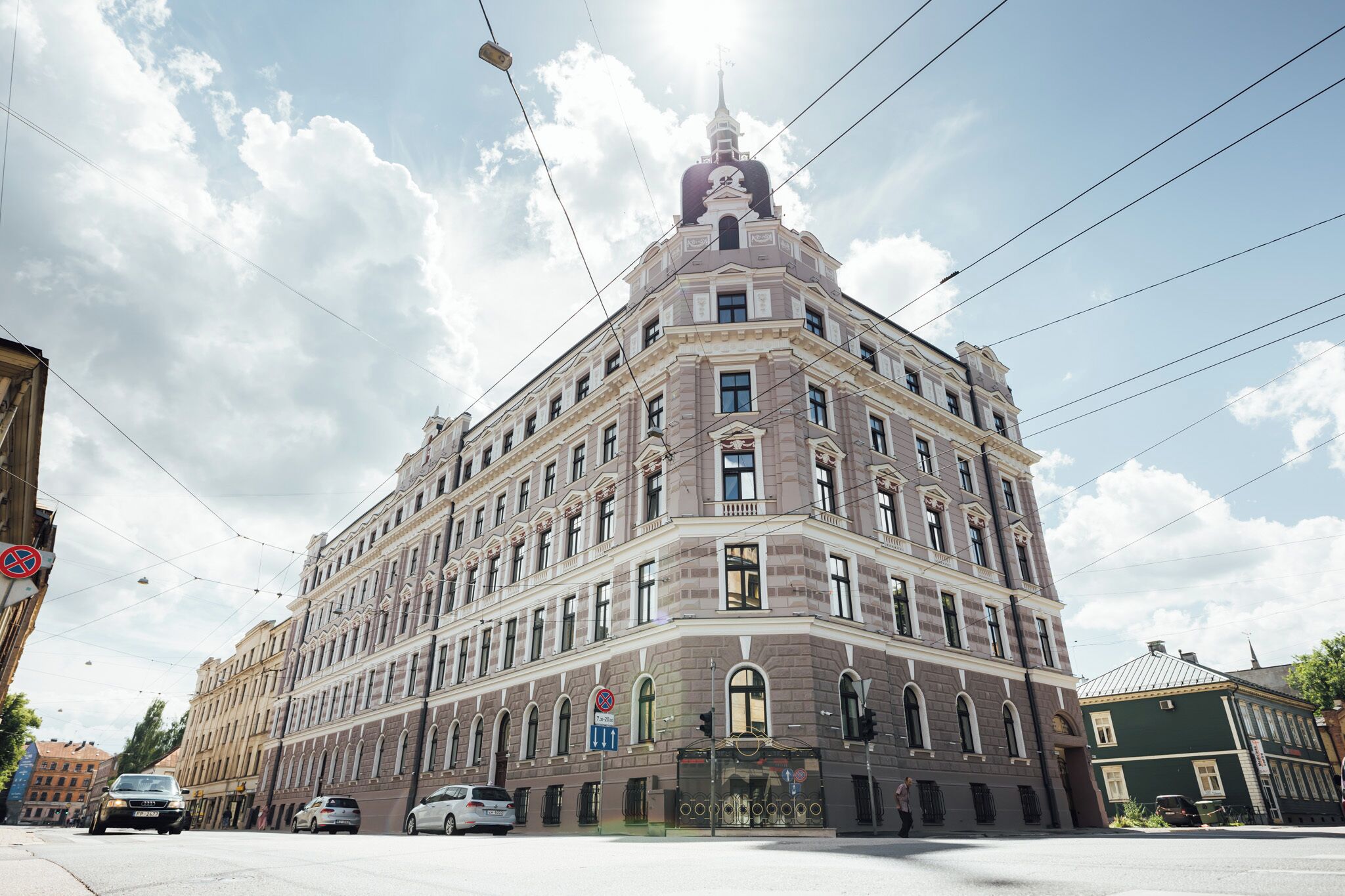 A historic building with a prominent corner tower and multiple windows.
