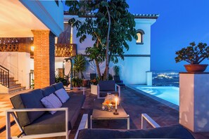 An infinity pool, a heated pool, sun loungers