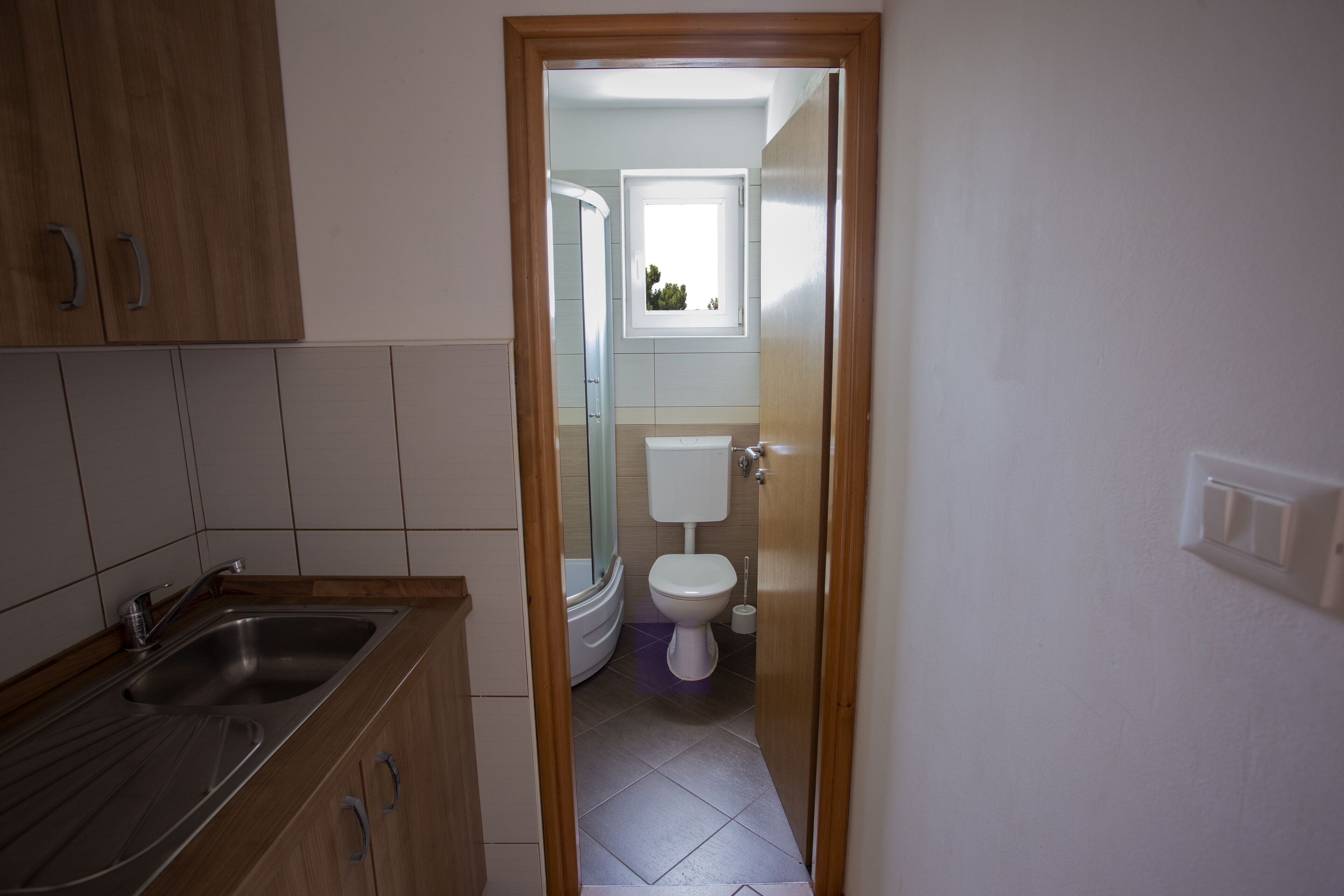 A modern bathroom with a toilet, sink, and shower.