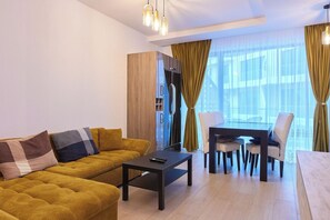 Comfort Apartment | Living area | 140-inch Smart TV with cable channels, TV