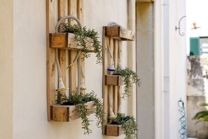 A rustic wall-mounted planter with greenery and a vintage-style light fixture.
